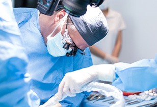 A male dentist performing a dental implant surgery
