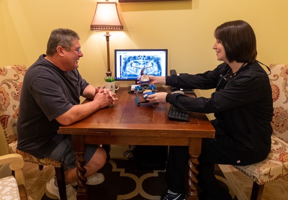 Dentist and patient discussing dental treatment plan