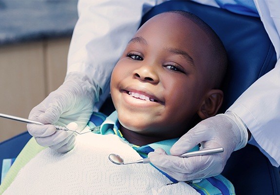 Smiling boy receiving dental sealants