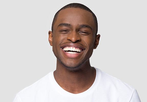 Young man showing off his smile makeover