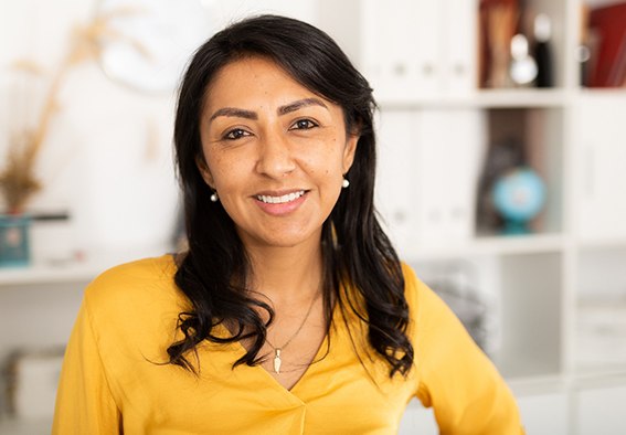 woman smiling after learning the cost of cosmetic dentistry