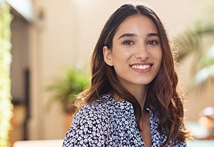 woman smiling after finding out how to make cosmetic dentistry affordable