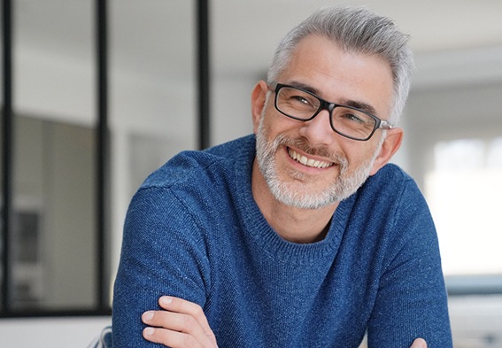 Man with glasses, blue sweater, and beard