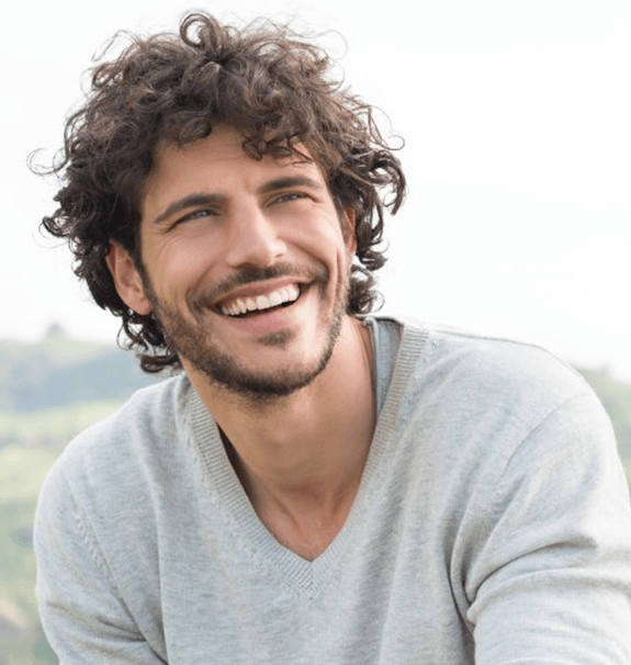 a man in New Braunfels smiling with new dentures