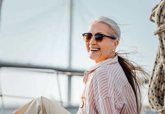 a woman with dentures smiling during the summer