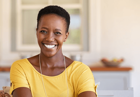 a woman smiling with her new dentures