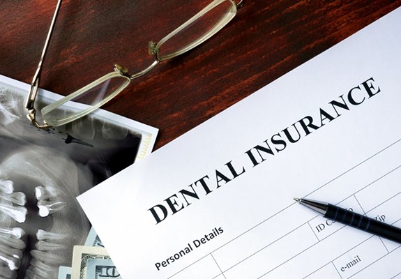 dental insurance form on brown wooden table 