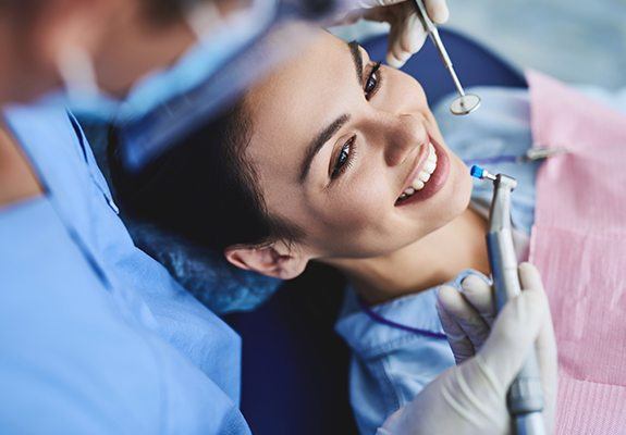 Woman receiving dental checkup to prevent emergency dentistry