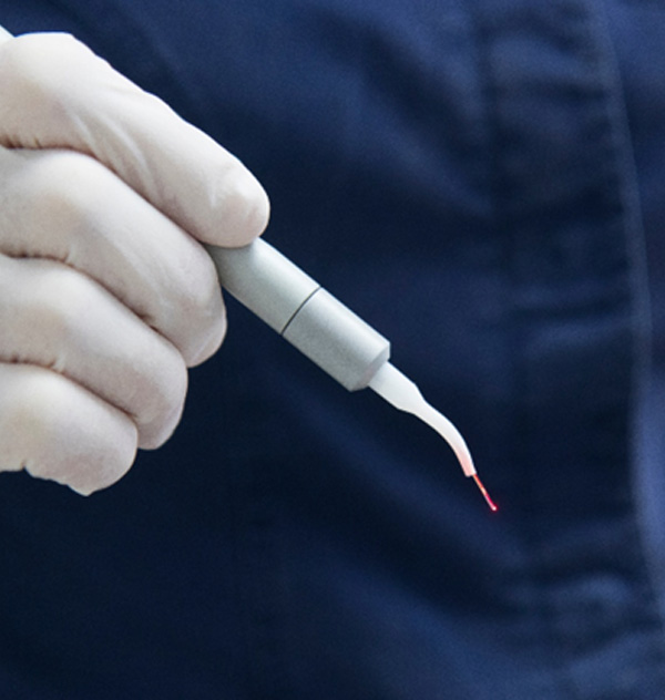 Dentist holding dental laser 