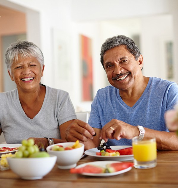 Happy middle-aged couple smiling after visiting their Humana dentist in New Braunfels