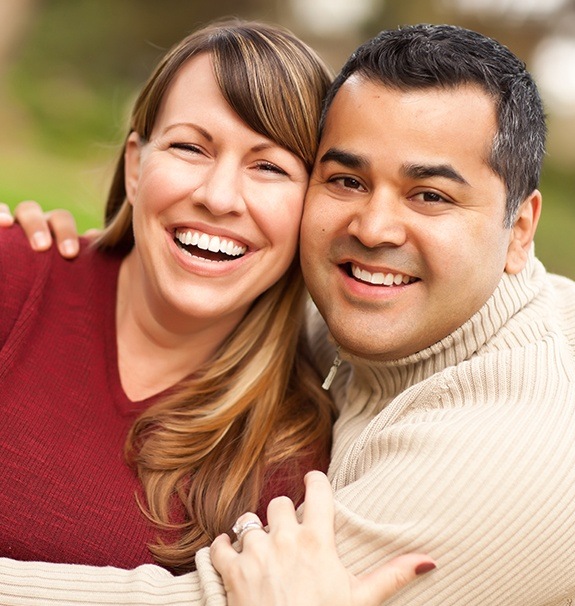 Man and woman smiling outdoors