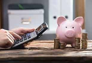 Calculator is used next to piggy bank?