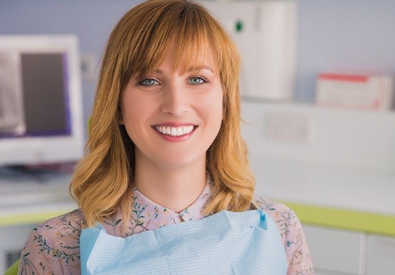 Woman in dental chair smiling after antibiotic therapy