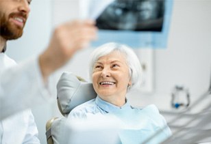 patient smiling while talking to dentist 