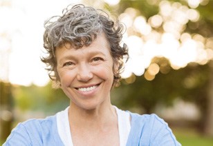 woman smiling while outside 