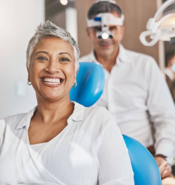 Happy senior patient in dental treatment chair