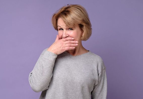Concerned woman covering her mouth?