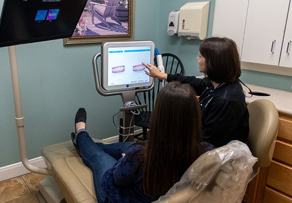 Dentist and patient looking at digital impressions