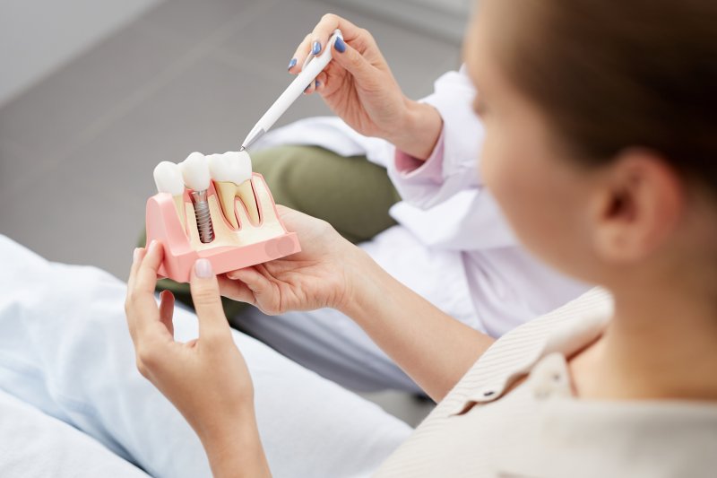 Dentist explaining how dental implants in New Braunfels work