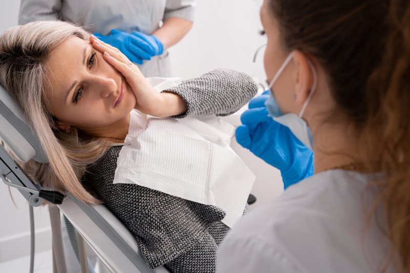 A woman getting treatment from an emergency dentist