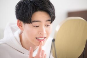 Man looking at the black line around his crown